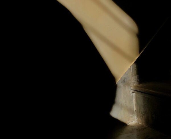 beginning corner of concrete staircase, dark shadow hovering