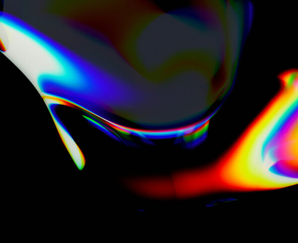 abstract and fluid, with iridescent bands of color flowing across a dark background. Vivid blues, reds, yellows, and greens blend and refract like light passing through oil or glass