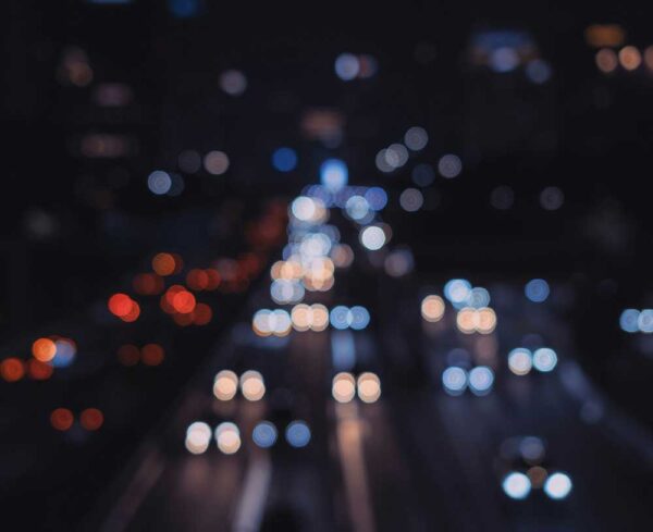 out of focus image of a highway and car lights