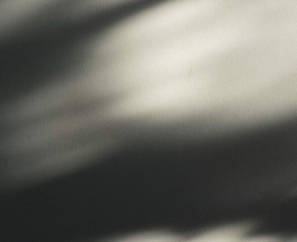 shadows on wall, light leaking through windows leaving shadows on beige wall