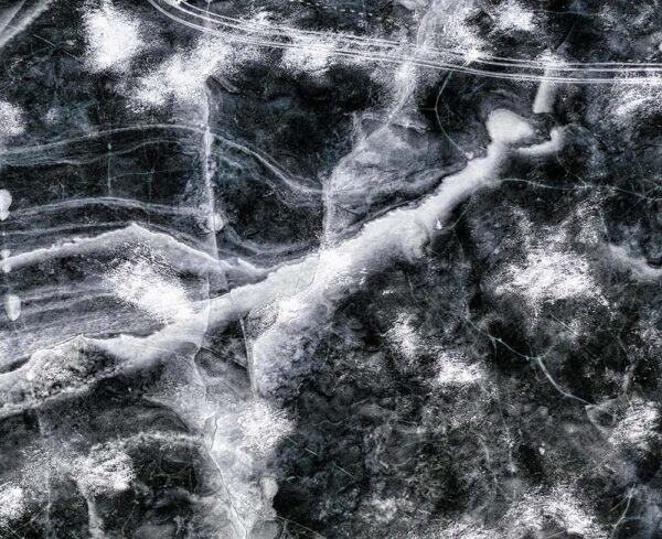 black-and-white textured image resembling marble, ice, or stone seen up close.