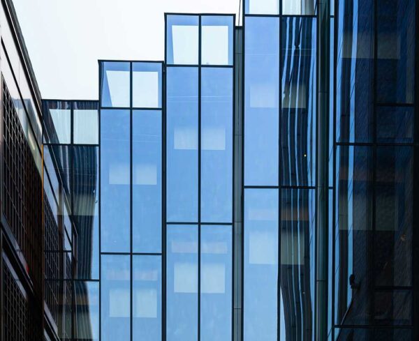 looking at corporate building with reflection from sky
