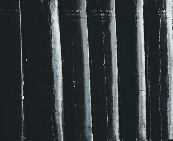 binding of black academic books lined up on a shelf