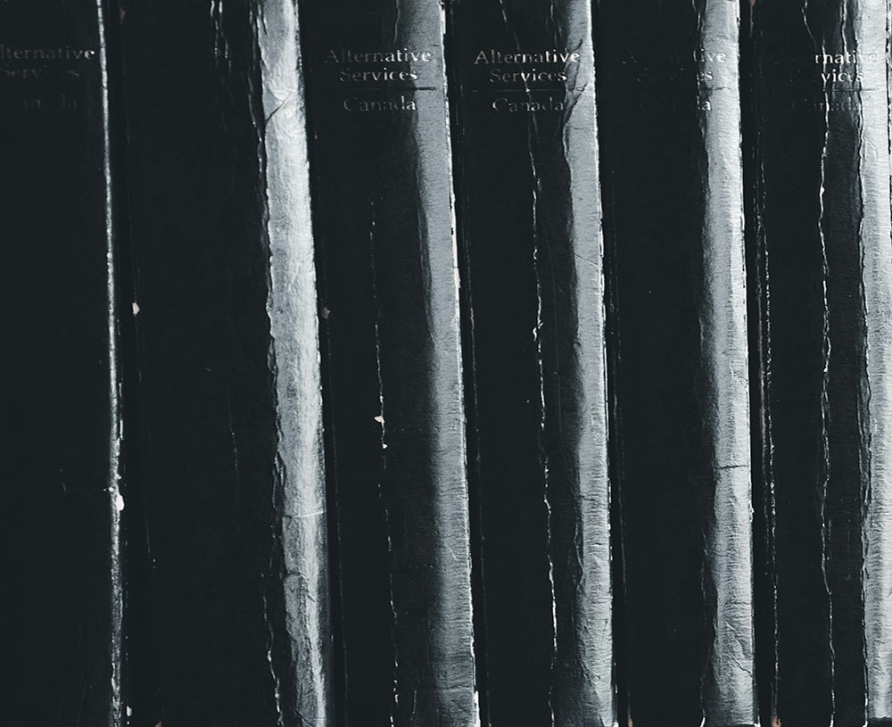 binding of black academic books lined up on a shelf