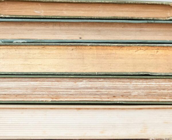 stack of books with yellowed pages insinuating intelligence