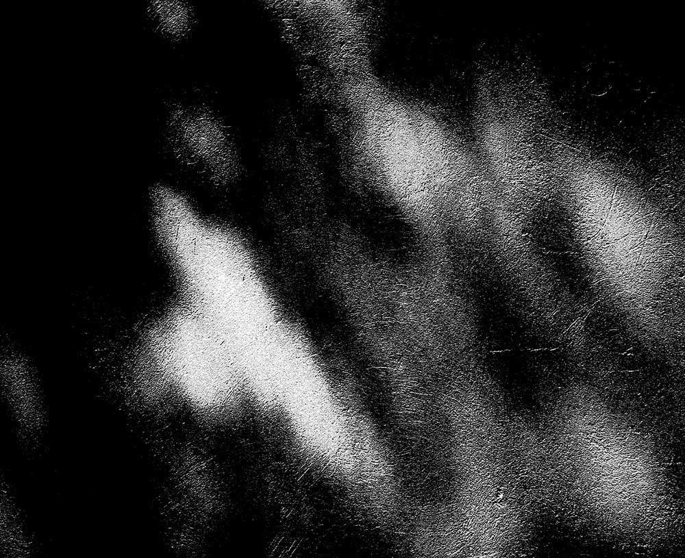 black and white image with light leaks coming through in a blur