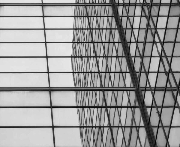Black and white building with reflection facing another building
