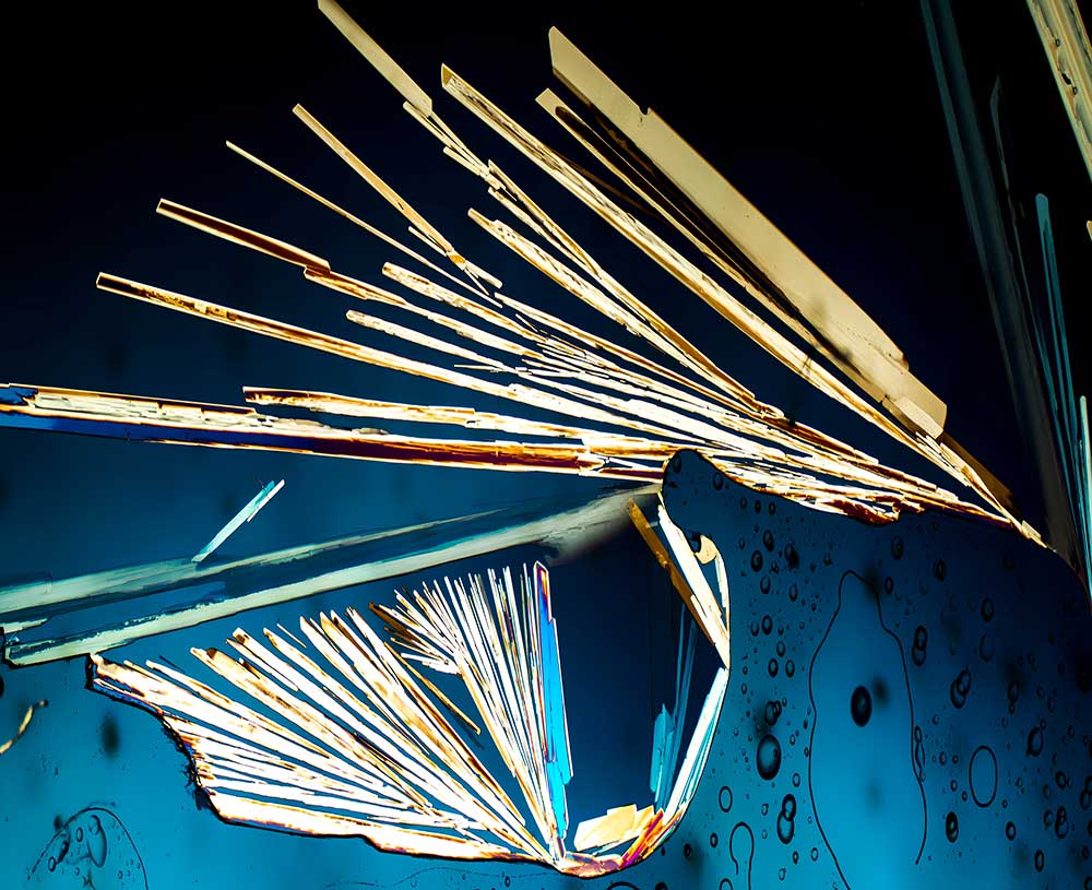 what looks like a broken window with rainbow shards and lines stemming from break