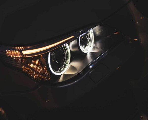 front headlight of car lit up in darkness