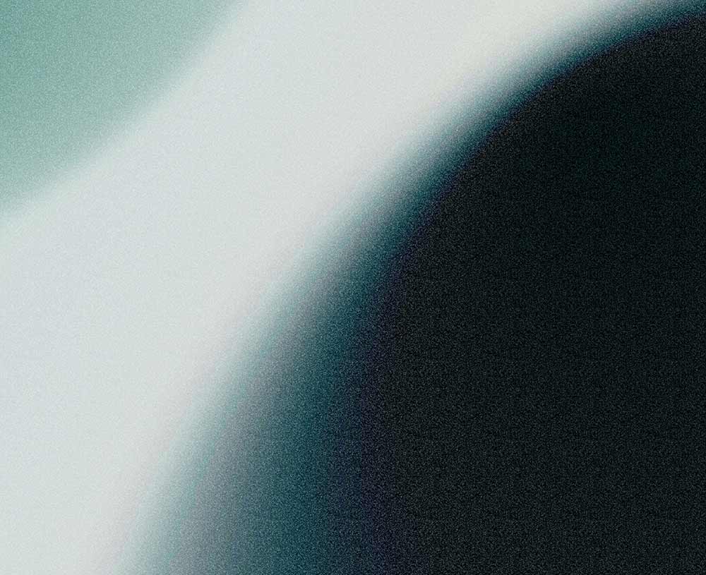 cool color gradient, going from light green to a cool white, transitioning to a light blue and black circle