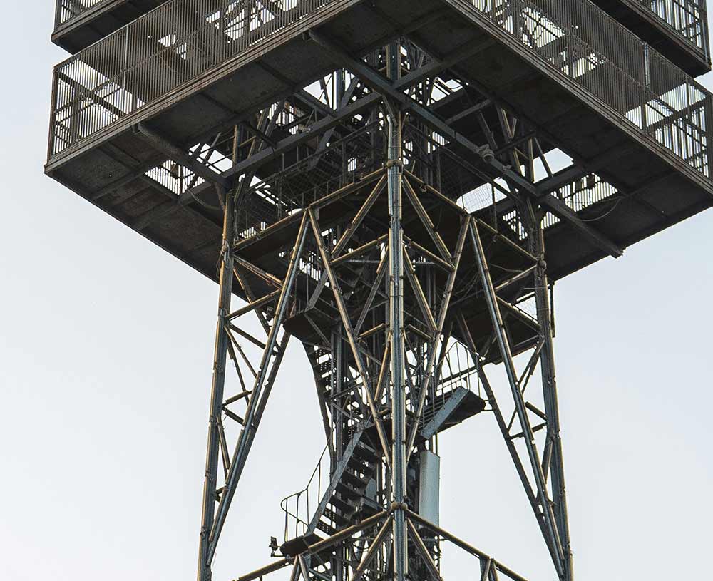close up of a moody grey telecommunications phone tower with grey sky