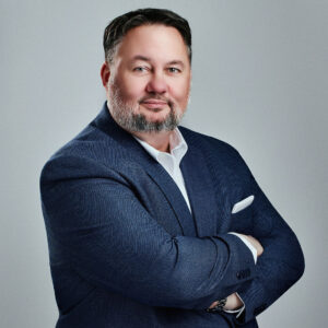 Andy Cepregi looking into the camera angled to the right with arms crossed.