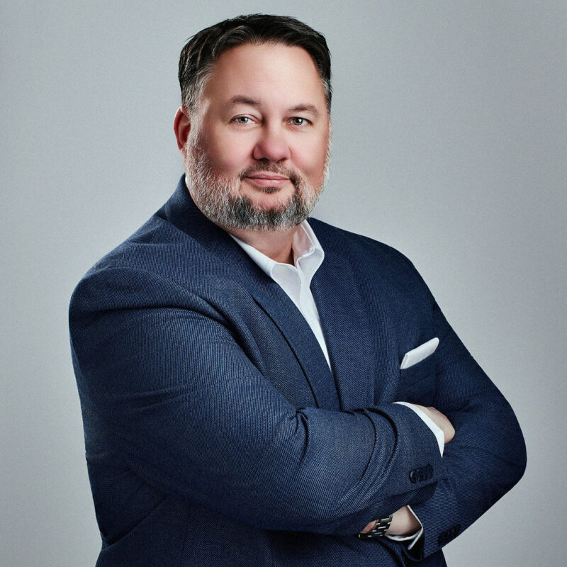 Andy Cepregi looking into the camera angled to the right with arms crossed.