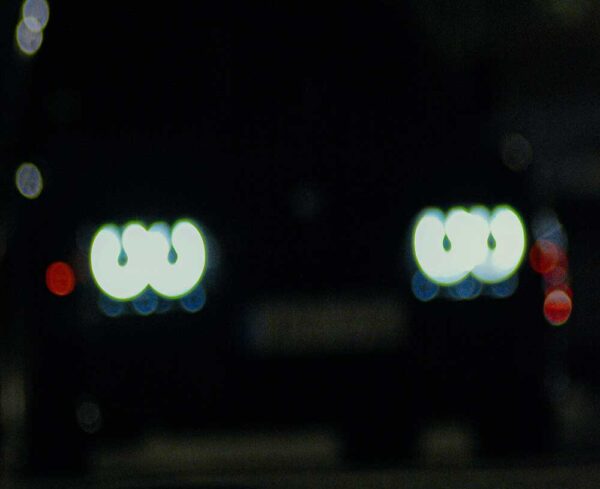 car headlights blurred in the darkness