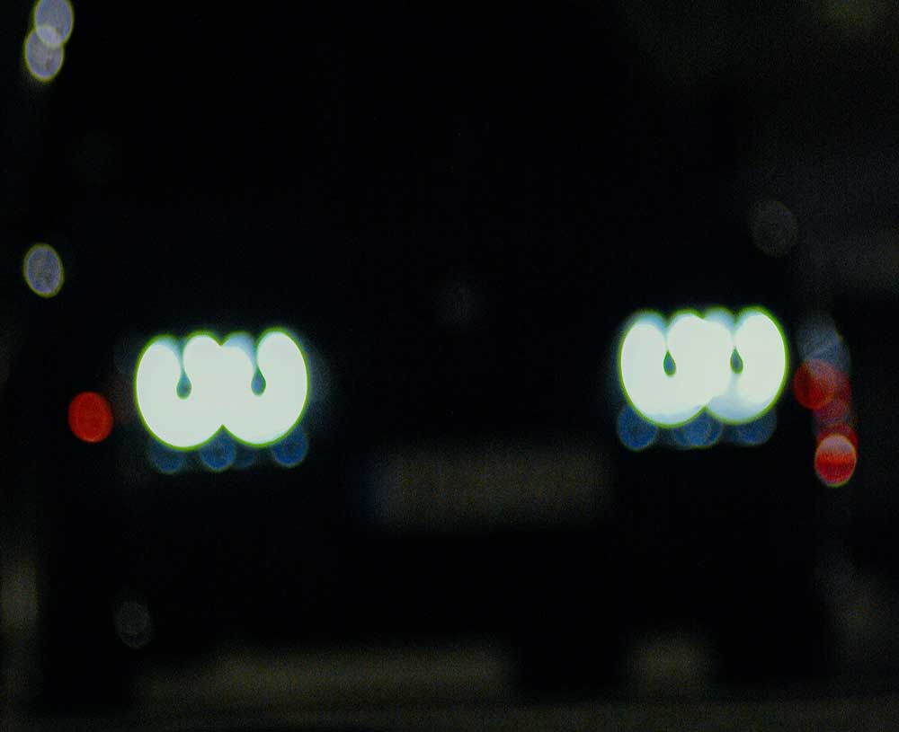 car headlights blurred in the darkness