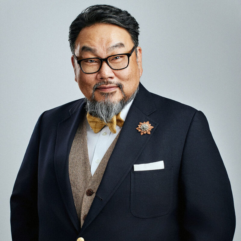 Daniel Lee looking straight into the camera slightly angled to the left with arms at the sides.