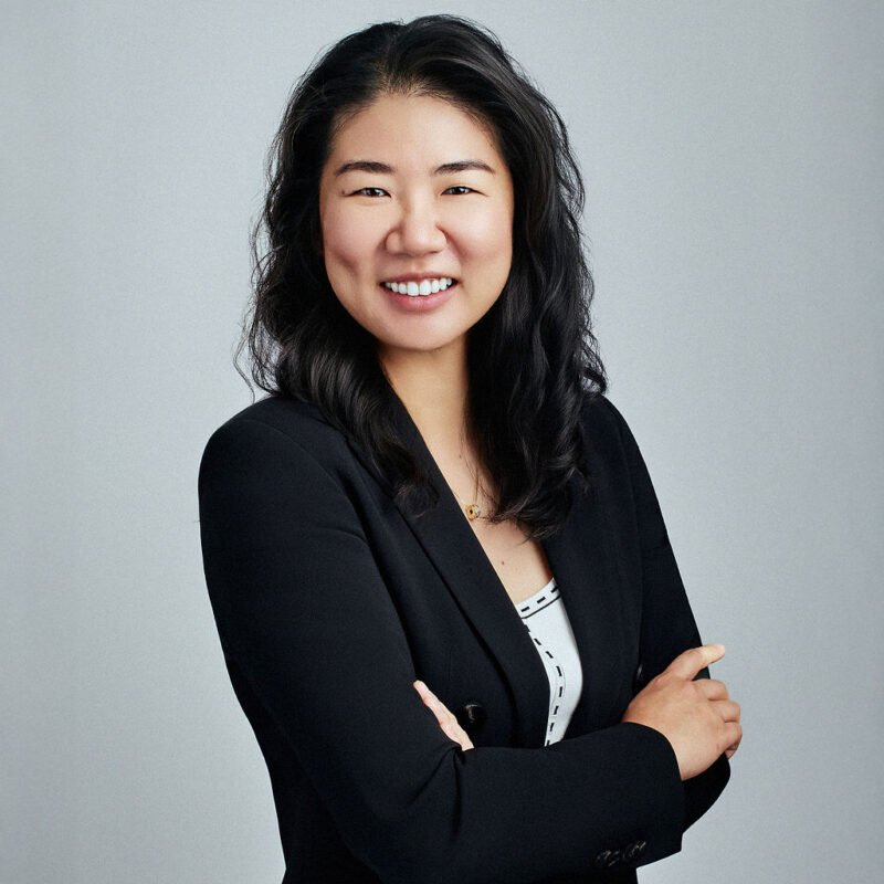 Kristy Park looking into the camera smiling angled to the right with arms folded.