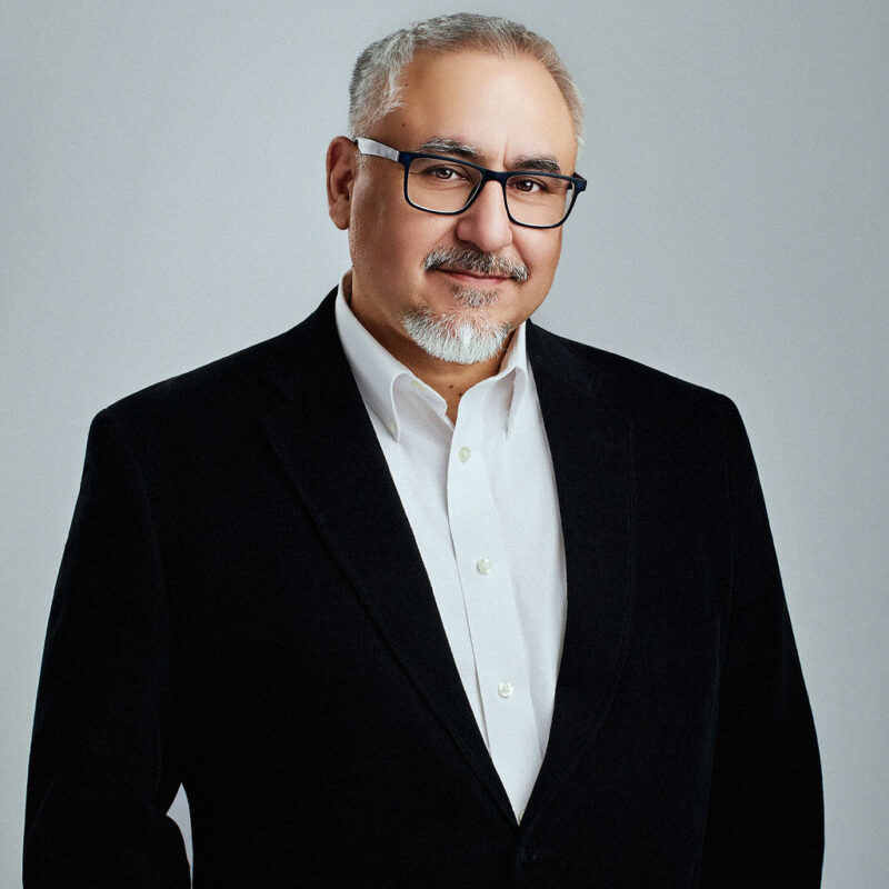 Manuel Reese looking straight into the camera slightly angled to the right with arms at the sides.