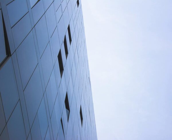 glass facade of building, blue sky