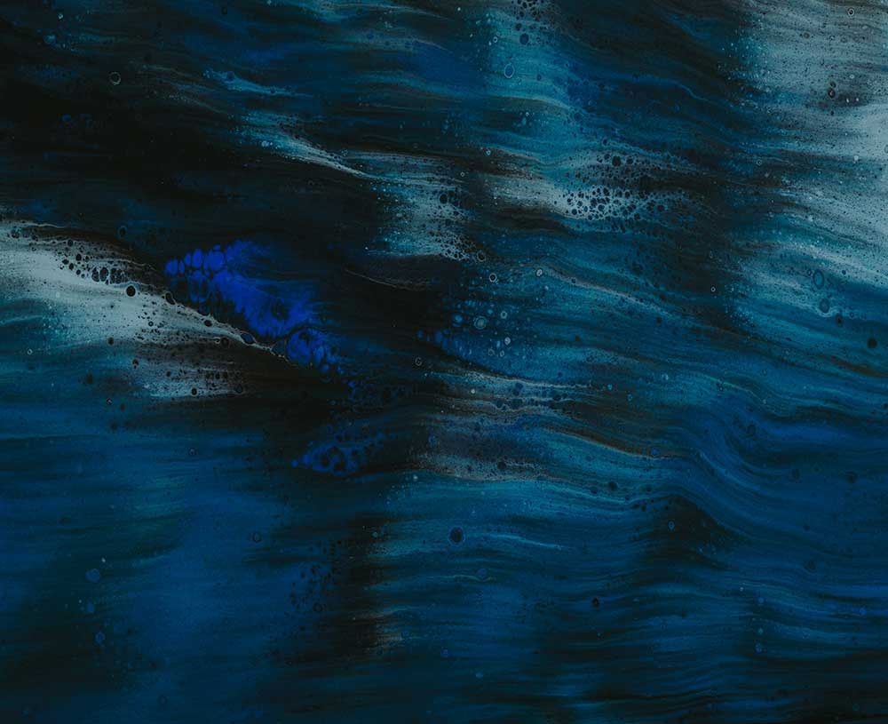 blue toned ink blots on dark background