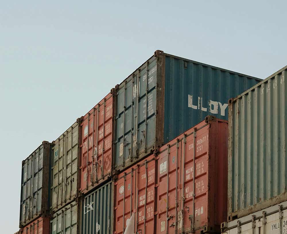 multi colored shipping containers stacked on top of one another