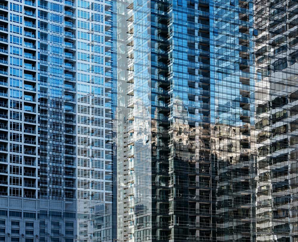 looking at a building with a blue sky reflecting in the background