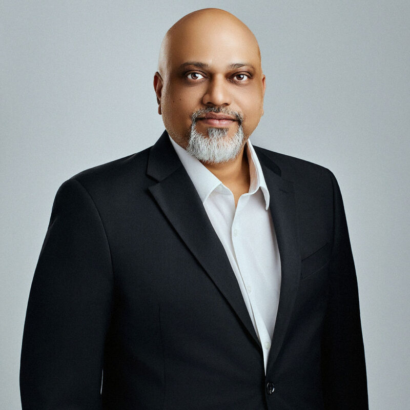 Ruke Keragala looking straight into the camera with arms at his side.