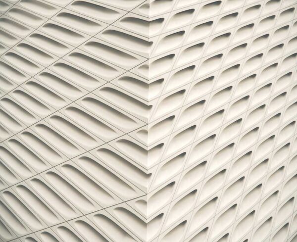 a white wall with an open texture on it illustrating a sense of movement