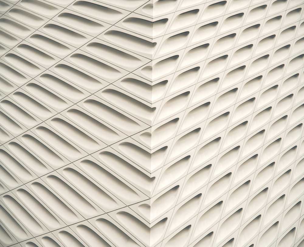 a white wall with an open texture on it illustrating a sense of movement