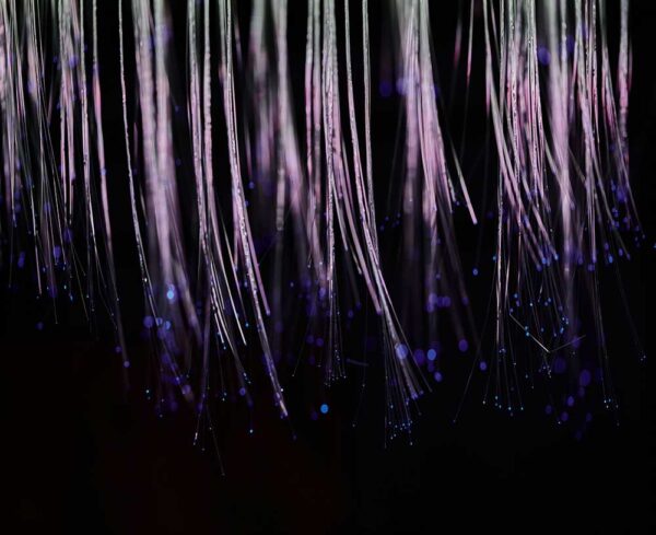 black background with lit up fiber cables